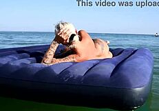 nude blonde beauty exposes big boobs on public beach with dolphin tattoo