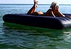 nude blonde beauty exposes big boobs on public beach with dolphin tattoo