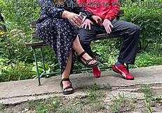 Milf subtly jerks big dick into glass on park bench