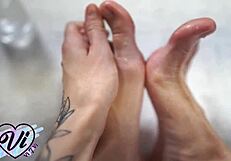 Oiled brunette teen teases tattooed feet and legs in closeup fetish display
