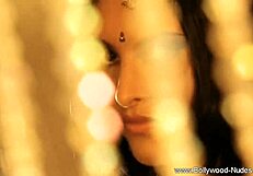 the erotic indian brunette slowly strips teasing her nude curves in a seductive dance