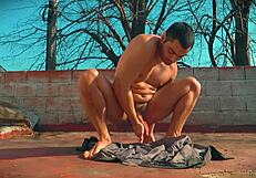 Muscular bodybuilder's monster cock and feet bask in outdoor sun allure