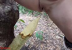 perverted bbw milf slut impales pussy on wooden stake squirting piss in forest