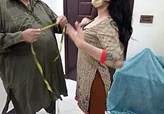 beautiful pakistani girl tries on outfits at busy tailor shop