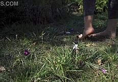 Barefoot toes tease and crush flowers across the grassy ranch