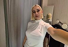 She slips into sheer transparent outfits in mall fitting room flashing big tits