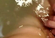 Woman enjoys extended bath session with self-touching and relaxation