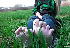 oh man my goddess feet look so cute in white socks jeans on spring grass