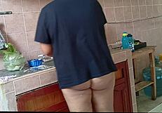 Chubby curvy stepmom cleans kitchen scrubbing every corner diligently