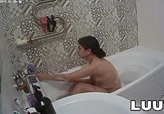 Luuv Vilika bares small tits in private late-night bathroom flash voyeur